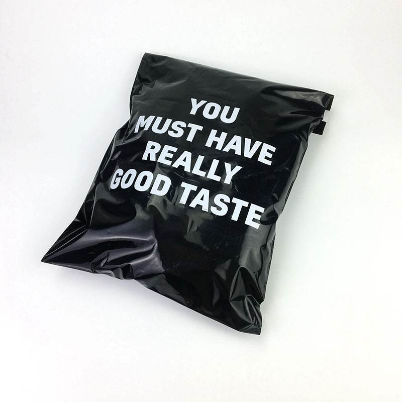 Black poly mailer printed with a large white message across the front panel