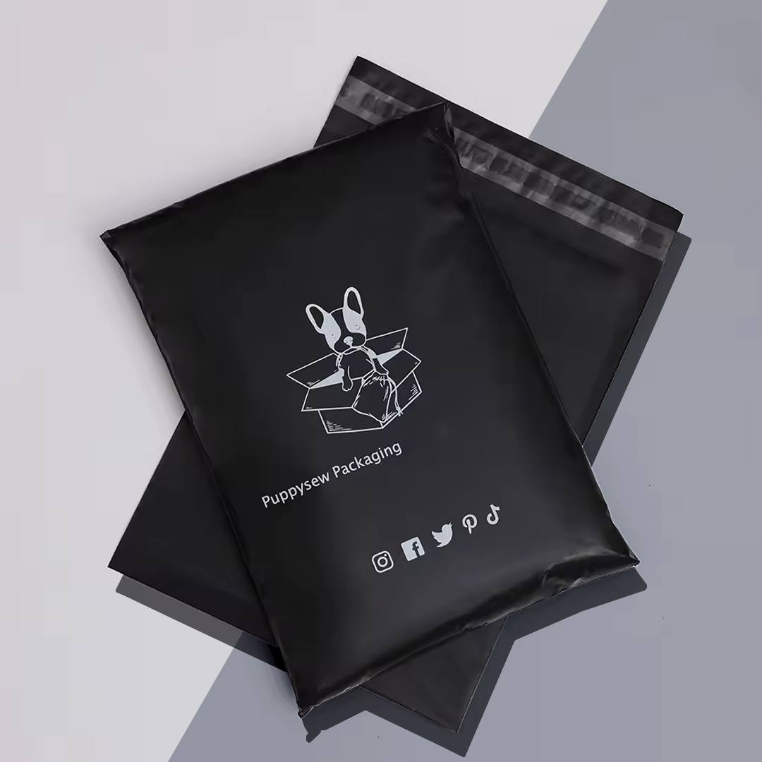 Two black poly mailers printed with a customer logo and social media icons