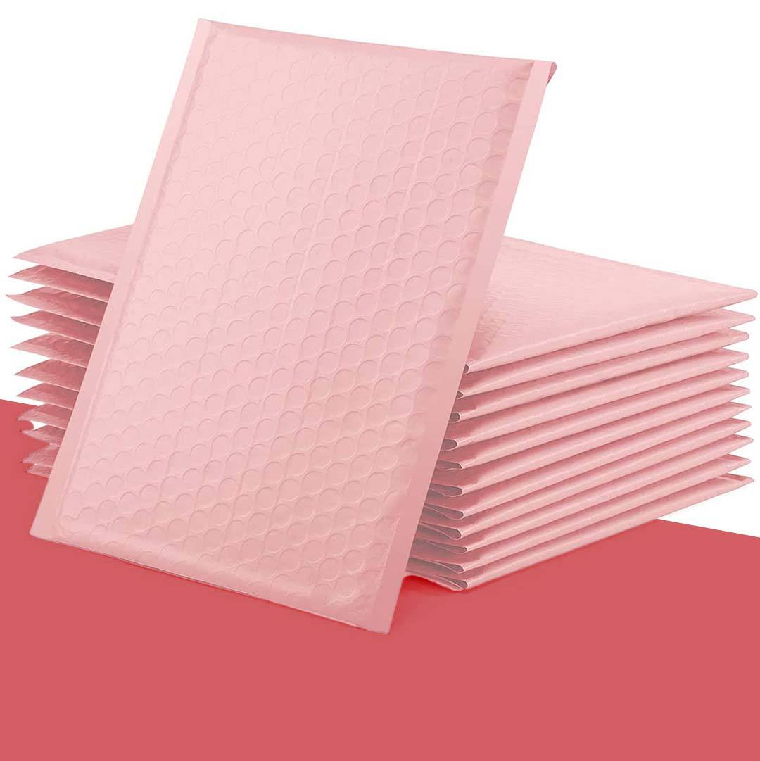 Stack of blush pink bubble-lined mailers with the cushioned surface visible
