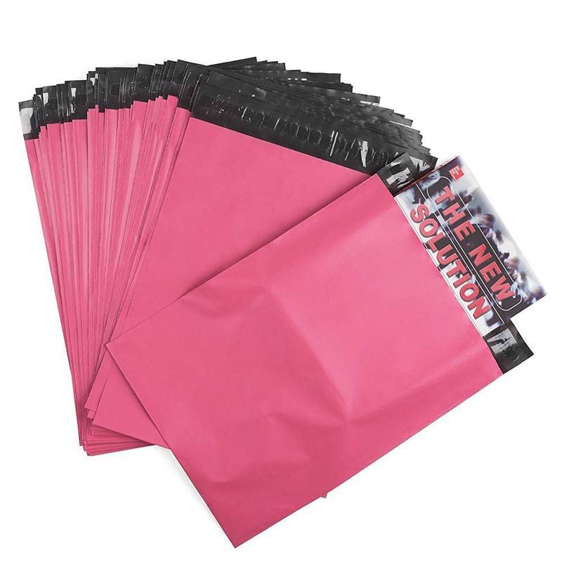 Deep pink poly mailers in a stack, one holding a printed insert card at the opening