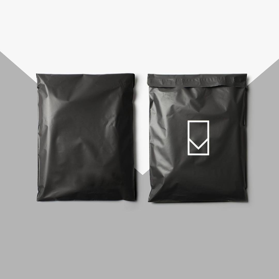 Matte black poly mailers shown front and back, one printed with a white line mark
