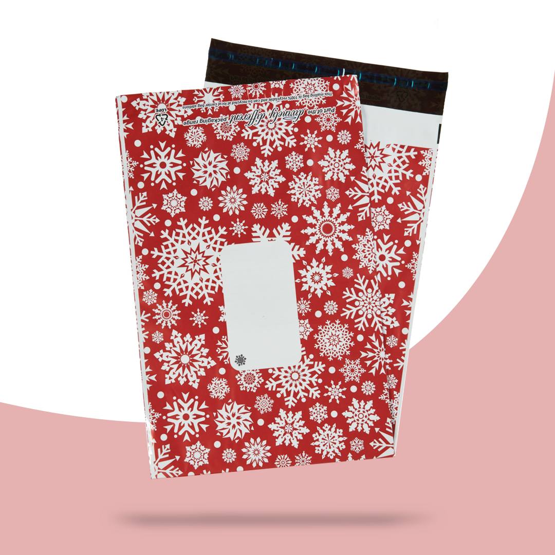 Red mailer printed with white snowflakes and a clear white panel left for the address label