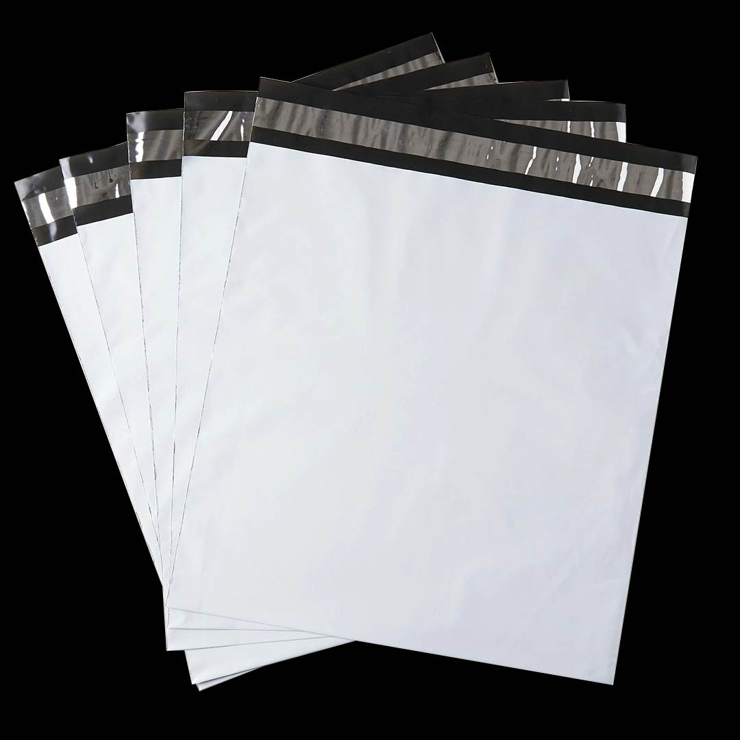 Fanned stack of unprinted white poly mailers with dark seal strips