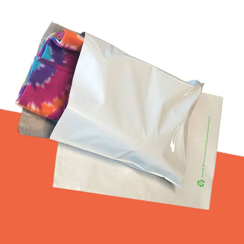 Plain mailer opened to show a folded garment, with no environmental printing on the panel