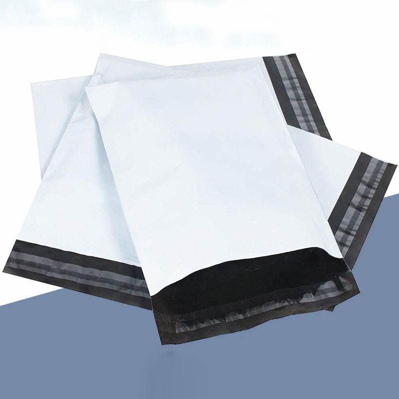 Three white poly mailers fanned out with dark seal strips along the closure edge