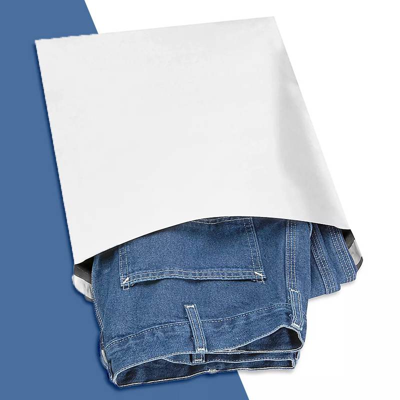 White self-seal mailer open at the top with a folded pair of jeans inside